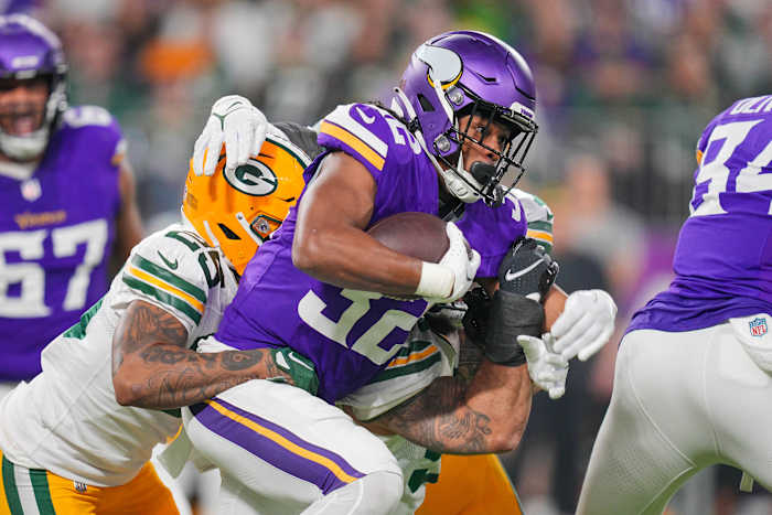 Dec 31, 2023; Minneapolis, Minnesota, USA; Minnesota Vikings running back Ty Chandler (32) runs with the ball against the Green Bay Packers in the first quarter at U.S. Bank Stadium.